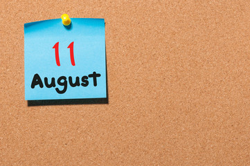 August 11th. Day 11 of month, color sticker calendar on notice board. Summer time. Empty space for text