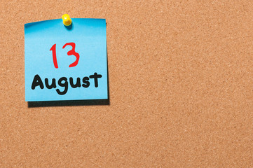 August 13th. Day 13 of month, color sticker calendar on notice board. Summer time. Empty space for text