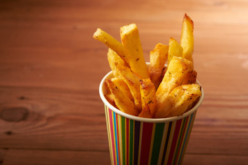 fried French fries close up in paper cup