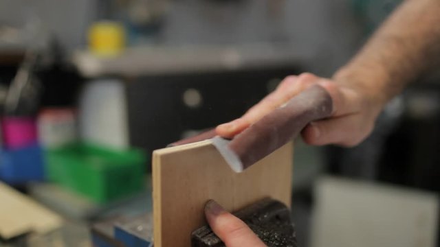 Close up on hand sanding wood