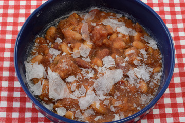 Leftover chicken chili frozen directly in blue bowl