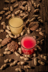 oatmeal cookies and juice in a glass on a wooden background with nuts