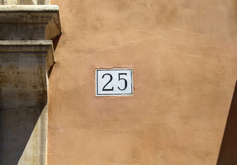 View of building number (25) on old, traditional surface in Rome