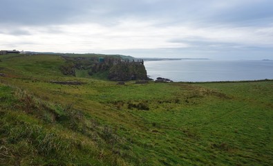Ruins of the medieval Dunluce Castle on a cliff in Northern Ireland