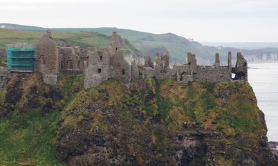Fototapeta na wymiar Ruins of the medieval Dunluce Castle on a cliff in Northern Ireland