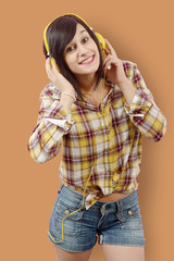 pretty young brunette listening to music with headphones