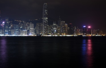 Obraz na płótnie Canvas Beautiful night view of Hong Kong island skyline across Victoria Harbour from Avenue of Stars at Kowloon. Skyscrapers on waterfront in downtown. Global financial center.