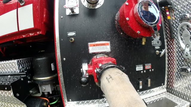 Leaking fire hose attatched to engine
