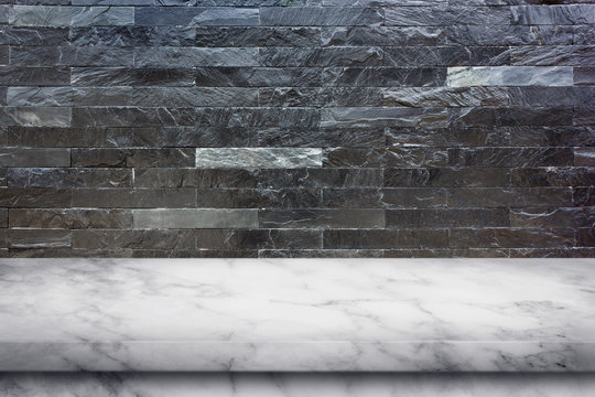 Empty top of marble table on black marble stone wall background.