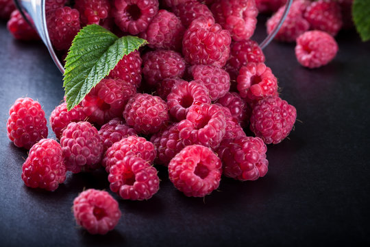 A bucket with scattered berries