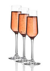Glass of pink rose champagne with bubbles on white