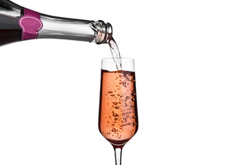 Pouring pink rose champagne from bottle to glass
