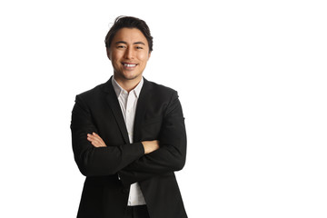 An attractive businessman wearing a black blazer with a white shirt, standing against a white background looking at camera. Smile on his face.