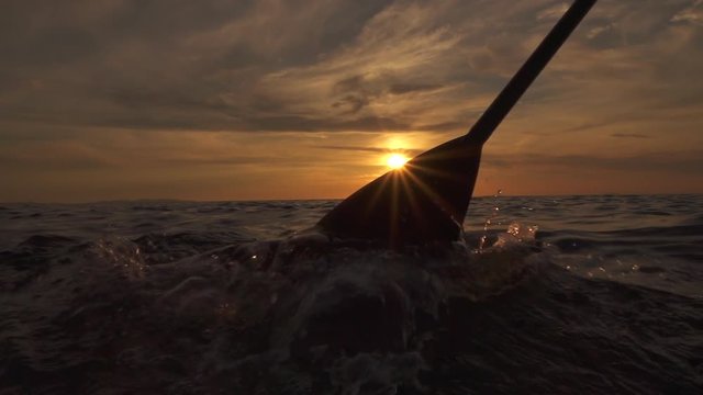 SLOW MOTION CLOSE UP: Sea bubbling when pushing paddle blade through ocean water