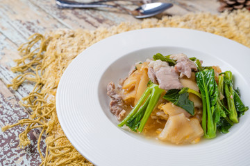 Fried noodle with pork and kale soaked in gravy