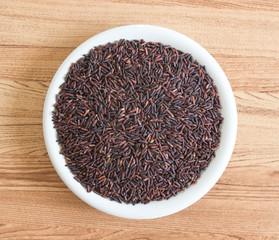 Riceberry or purple rice for good healthy in bowl, top view shot