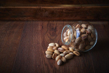 Pistachios over dark background. Food background with copyspace.  Studio photography. Object shooting.