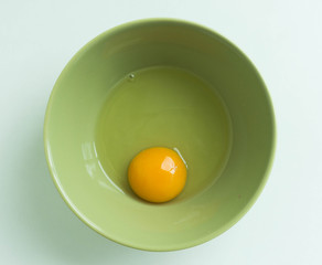 Egg yolk and white in a bowl