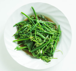 Fried bitter gourd leaf with oyster sauce ,This is a local Thai