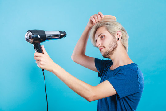 Trendy man with hair dryer