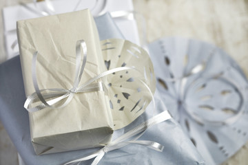 Christmas gift wrapped in paper with paper snowflakes