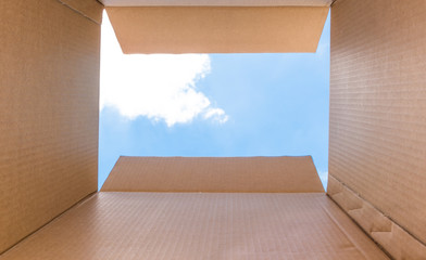 Concept image "Thinking Outside the Box" - Inside a cardboard with clear sky