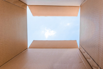 Concept image "Thinking Outside the Box" - Inside a cardboard with clear sky