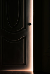 White Door opening in the Dark Room with shining of sunlight - Concept image