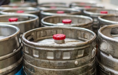 Many steel kegs of beer with red caps outside a pub in Carlton Melbourne Australia