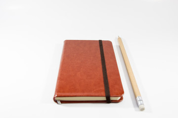Small brown notebook isolated in white background.