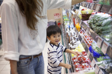 Mother and son have been shopping in the supermarket
