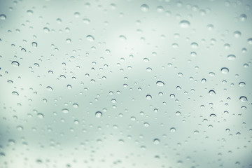 Rain drop on car glass in background.