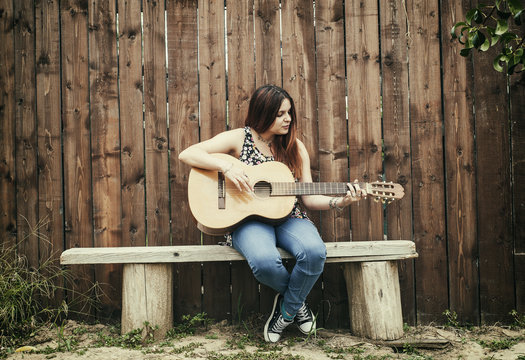 Beautiful girl playing her guitar