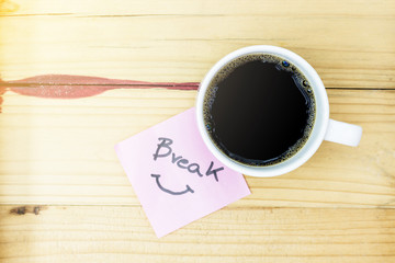 break in pink pos it and laptop keyboard, on red wood background