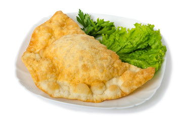 cheburek with lamb parsley and salad on white plate