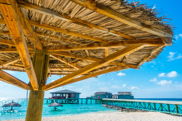 Wooden hut  in Maldives island with white sandy beach and sea .
