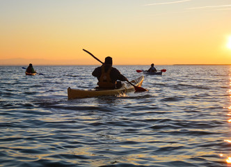 Kayaking at sunset on calm lake