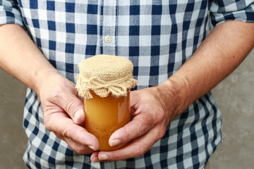 Man holding jar of honey