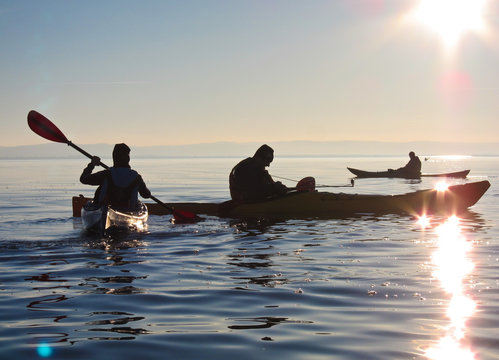 Kayaking At Sunset On Calm Lake