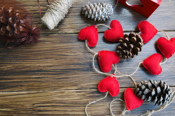 Christmas or New Year background. Making decoration for fir tree, felt heart garland and bobbins on...