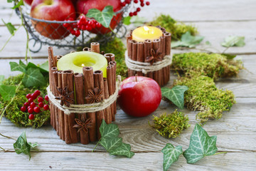 Candle decorated with cinnamon sticks