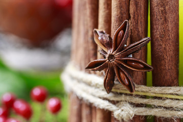 Obraz premium Candle decorated with cinnamon sticks