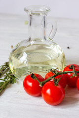 tomato with olive oil on wooden background