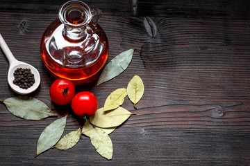 jar with oil and tomatoes on wooden background top view