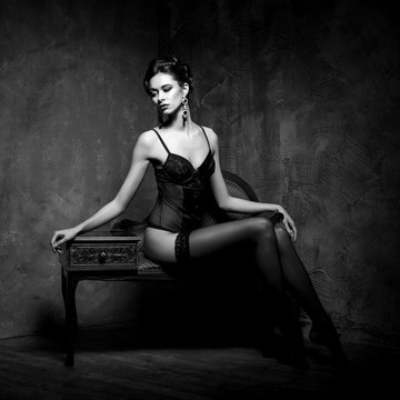 Woman in lingerie and stockings in a vintage interior