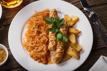 Baked Munich sausages with stewed cabbage, closeup