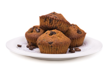 Muffins with chocolate filling cooked at home, on a white background