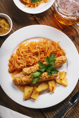 Baked Munich sausages with stewed cabbage and a glass of beer