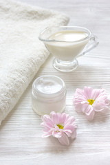 Plakat cream and spa on wooden background with flowers