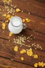 milk jug on wooden background top view